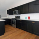 Illustration for article titled How Can I Get Small Kitchen Look Good with Black Cabinets by Vara Designs and Decors?em/em